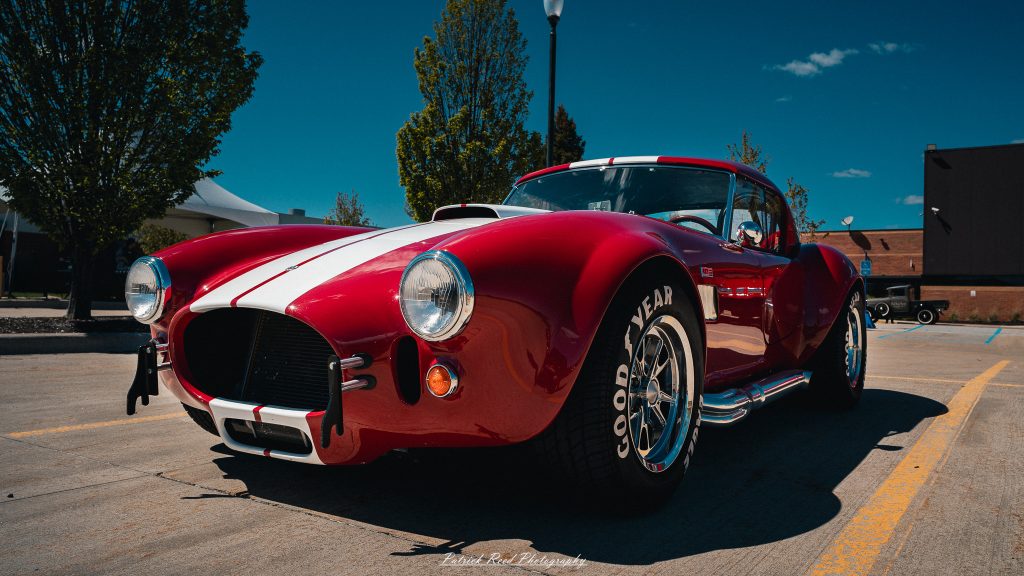 Classic car photography from a Michigan car show featuring vintage muscle cars, hot rods, classic trucks, and automotive detail shots captured in a cinematic documentary style.