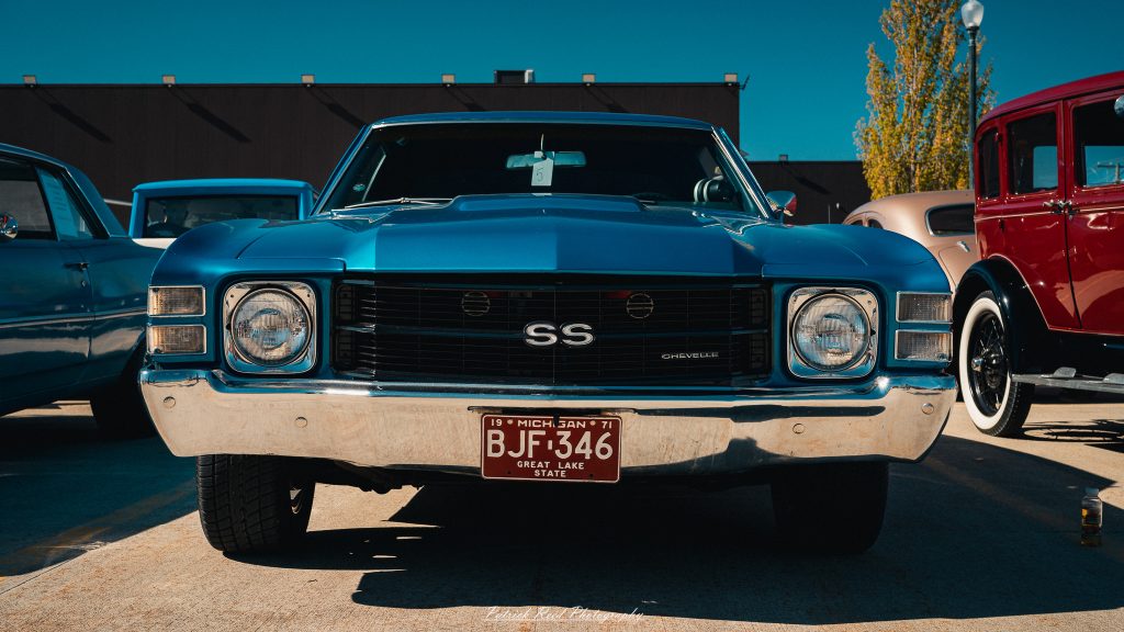 Classic car photography from a Michigan car show featuring vintage muscle cars, hot rods, classic trucks, and automotive detail shots captured in a cinematic documentary style.