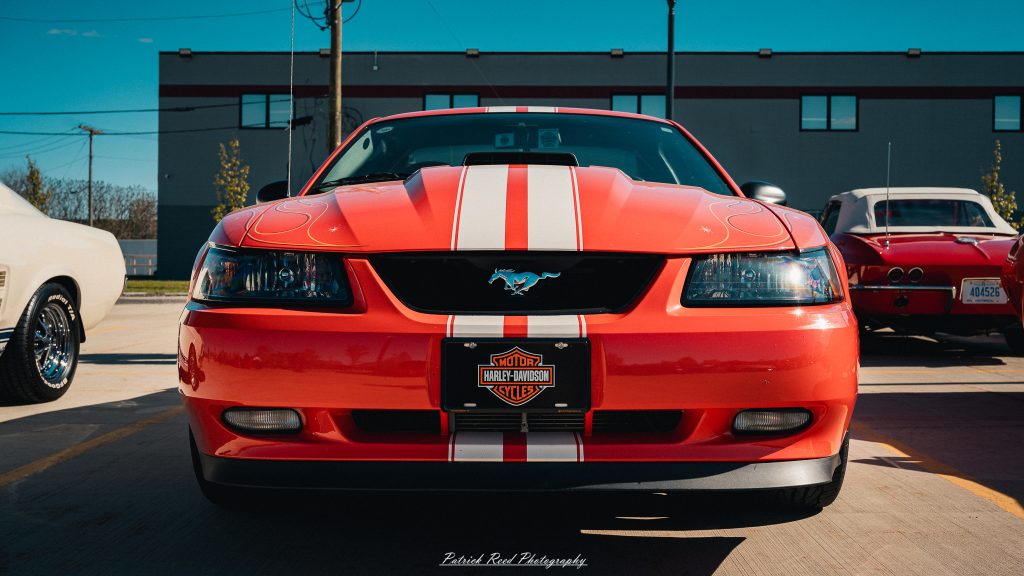 Classic car photography from a Michigan car show featuring vintage muscle cars, hot rods, classic trucks, and automotive detail shots captured in a cinematic documentary style.