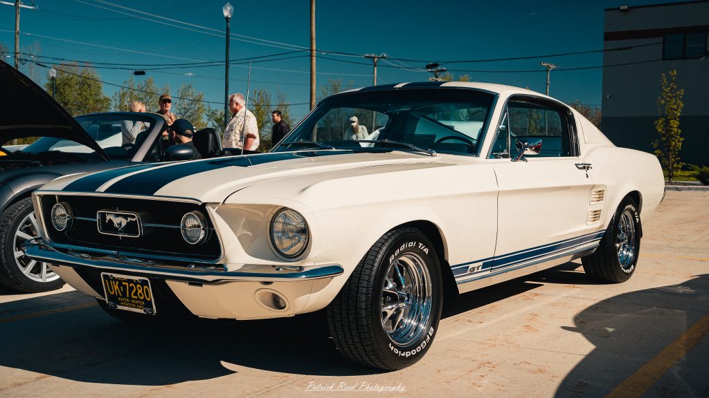 Classic car photography from a Michigan car show featuring vintage muscle cars, hot rods, classic trucks, and automotive detail shots captured in a cinematic documentary style.