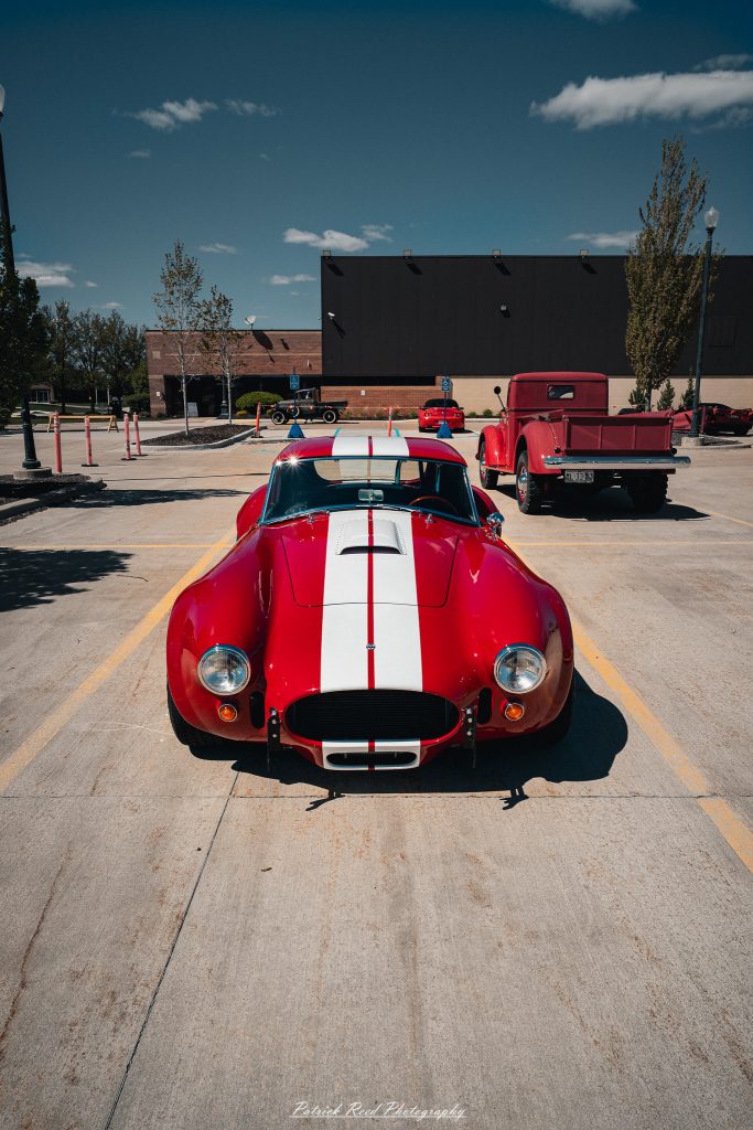 Classic car photography from a Michigan car show featuring vintage muscle cars, hot rods, classic trucks, and automotive detail shots captured in a cinematic documentary style.