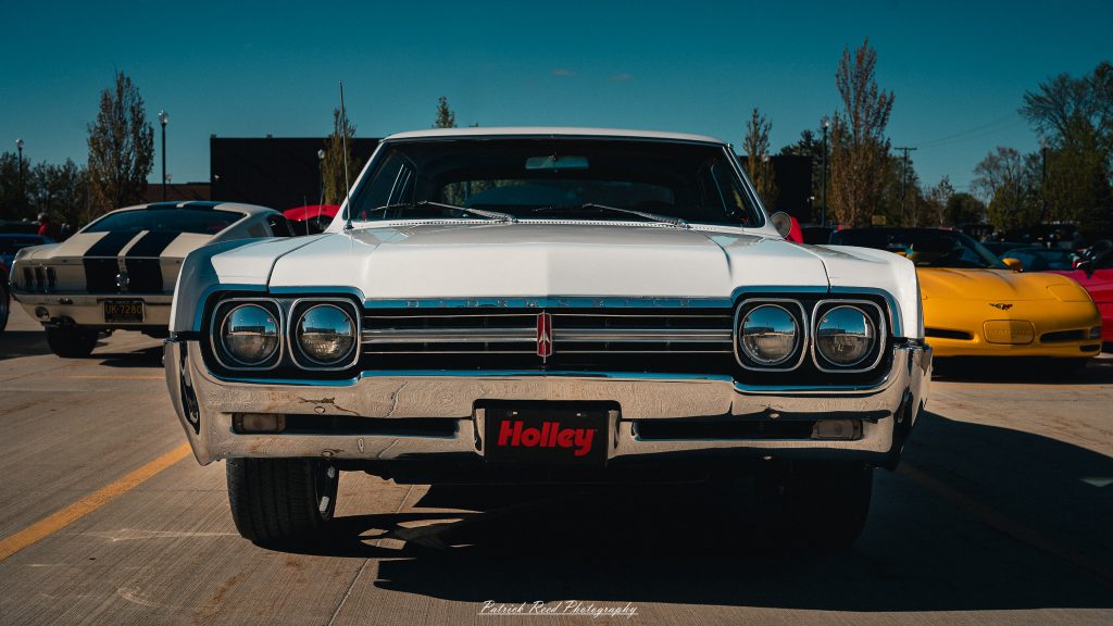 Classic car photography from a Michigan car show featuring vintage muscle cars, hot rods, classic trucks, and automotive detail shots captured in a cinematic documentary style.