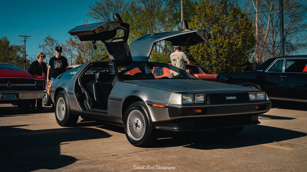 Classic car photography from a Michigan car show featuring vintage muscle cars, hot rods, classic trucks, and automotive detail shots captured in a cinematic documentary style.