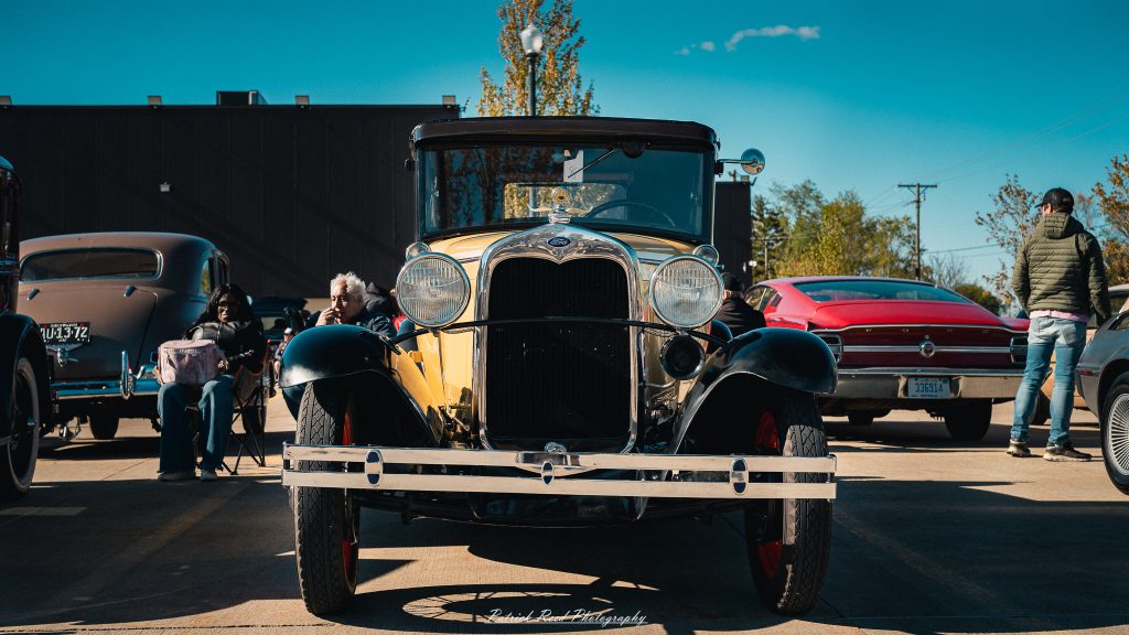Classic car photography from a Michigan car show featuring vintage muscle cars, hot rods, classic trucks, and automotive detail shots captured in a cinematic documentary style.