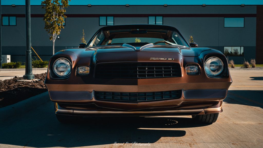 Classic car photography from a Michigan car show featuring vintage muscle cars, hot rods, classic trucks, and automotive detail shots captured in a cinematic documentary style.