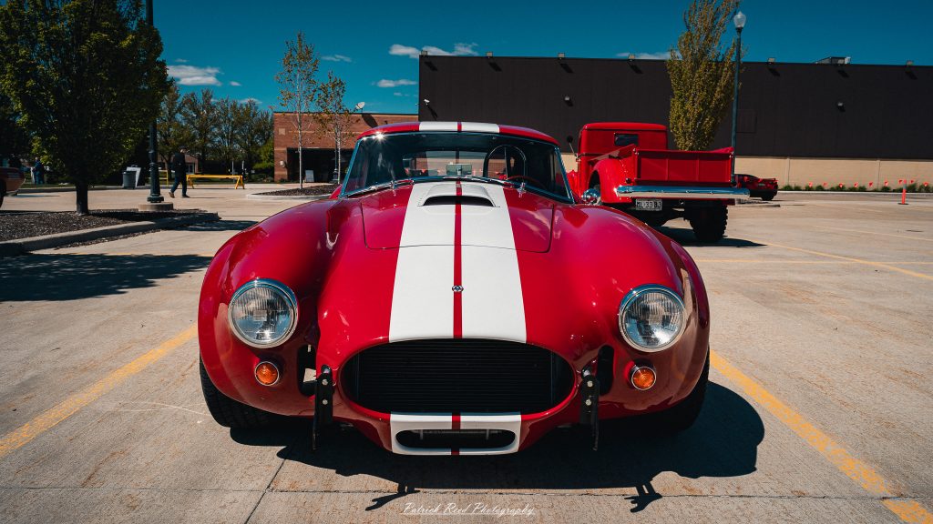 Classic car photography from a Michigan car show featuring vintage muscle cars, hot rods, classic trucks, and automotive detail shots captured in a cinematic documentary style.