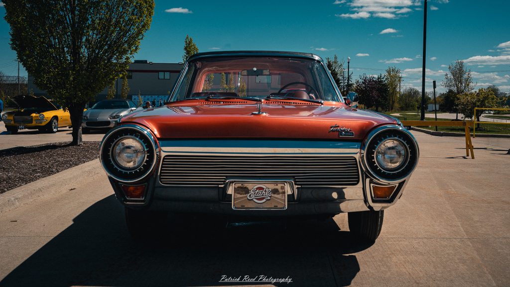 Classic car photography from a Michigan car show featuring vintage muscle cars, hot rods, classic trucks, and automotive detail shots captured in a cinematic documentary style.