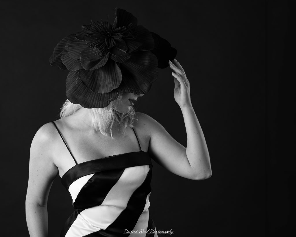 Studio fashion photography featuring model Hannah in avant-garde headwear, contemporary fashion styling, and retro-inspired editorial portraits captured with dramatic lighting and expressive posing.