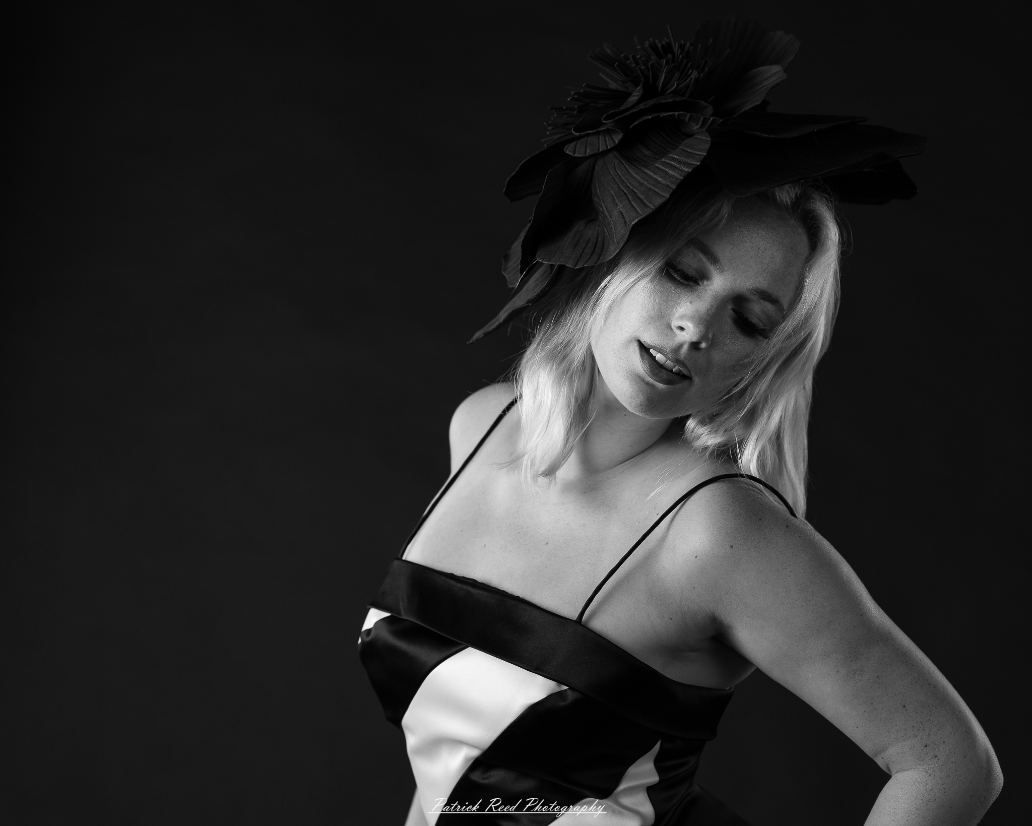 Studio fashion photography featuring model Hannah in avant-garde headwear, contemporary fashion styling, and retro-inspired editorial portraits captured with dramatic lighting and expressive posing.