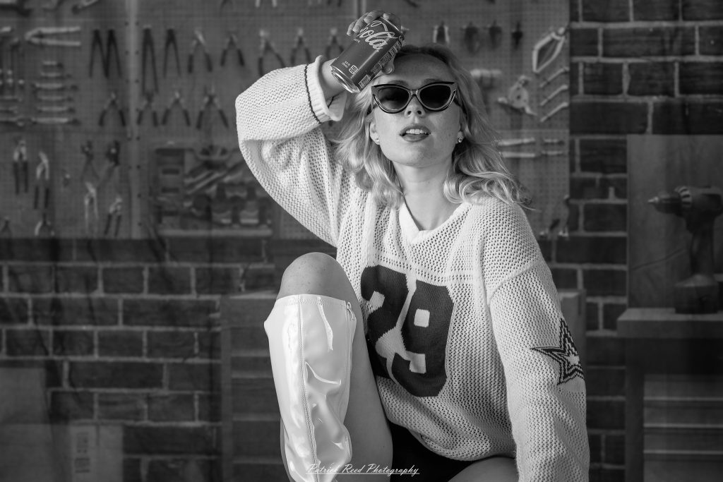 Studio fashion photography featuring model Hannah in avant-garde headwear, contemporary fashion styling, and retro-inspired editorial portraits captured with dramatic lighting and expressive posing.
