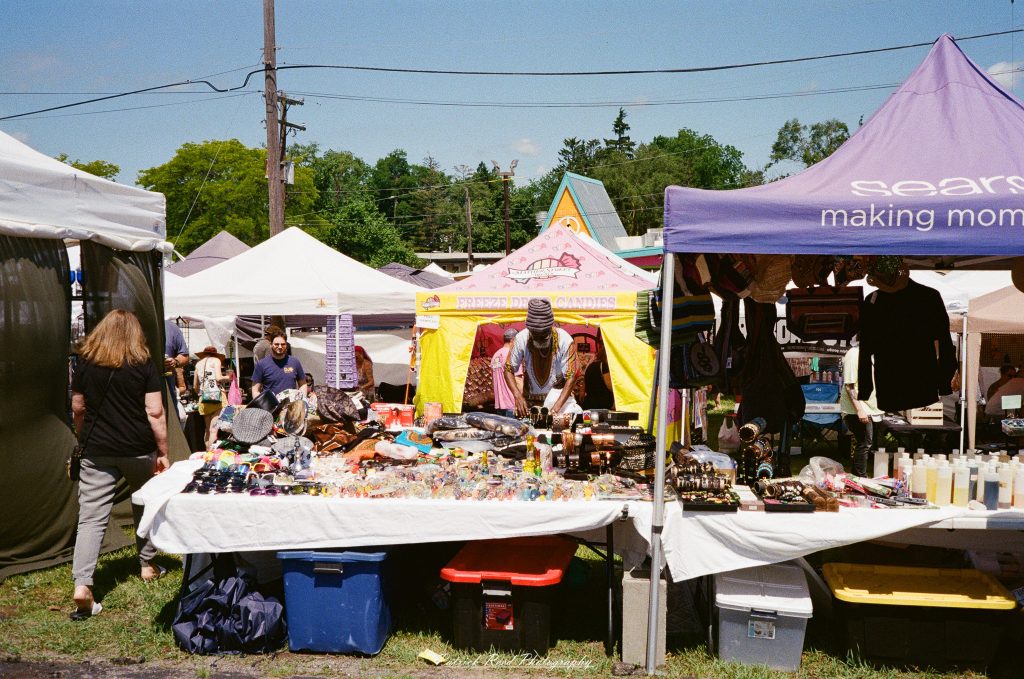 Street photography captured on a Rollei 35S at Peacefest in Waterford, Michigan, featuring festival attendees, live entertainment, community activities, and candid moments documented on 35mm film.