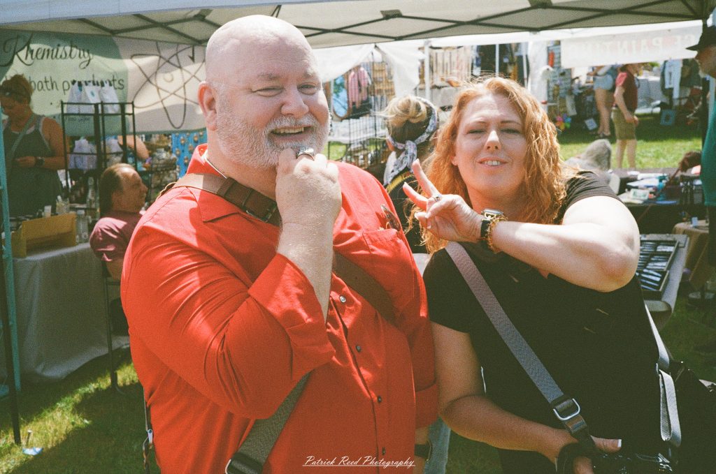 Street photography captured on a Rollei 35S at Peacefest in Waterford, Michigan, featuring festival attendees, live entertainment, community activities, and candid moments documented on 35mm film.