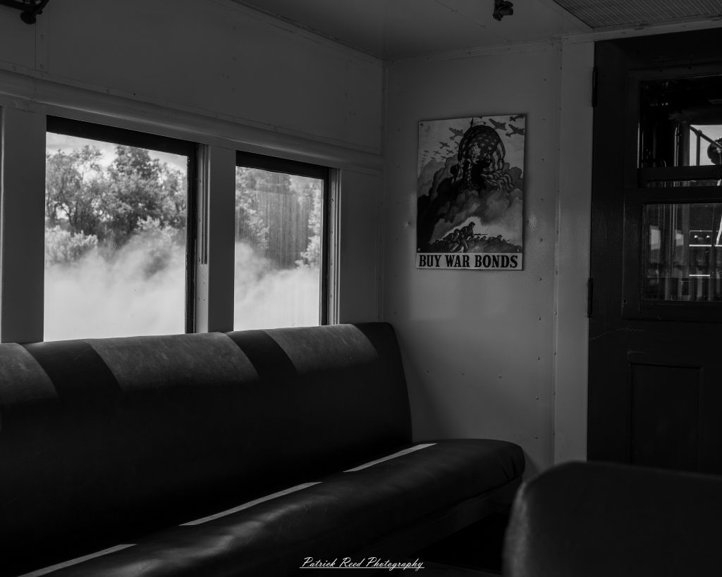 Black-and-white documentary photographs from the Steam Railroading Institute in Ohio, featuring historic steam locomotives, vintage passenger railcars, railroad machinery, restoration workshops, and industrial details preserving America's railroad heritage.
