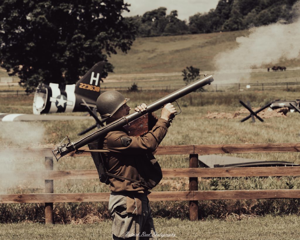 Documentary photographs of World War II reenactors at the Steam Railroading Institute, featuring authentic military uniforms, vintage trains, historical equipment, and living history demonstrations.