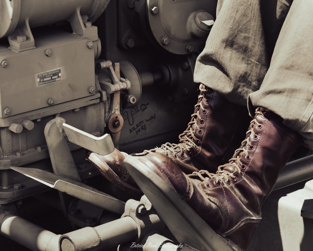 Documentary photographs of World War II reenactors at the Steam Railroading Institute, featuring authentic military uniforms, vintage trains, historical equipment, and living history demonstrations.