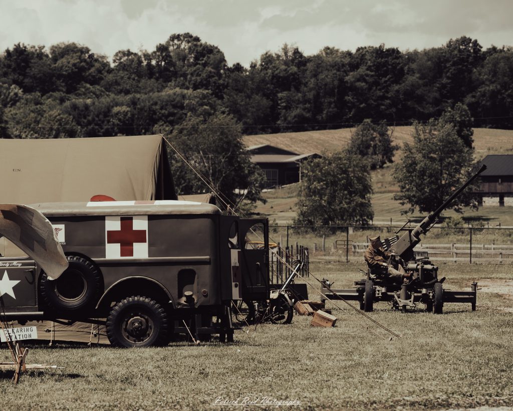 Documentary photographs of World War II reenactors at the Steam Railroading Institute, featuring authentic military uniforms, vintage trains, historical equipment, and living history demonstrations.