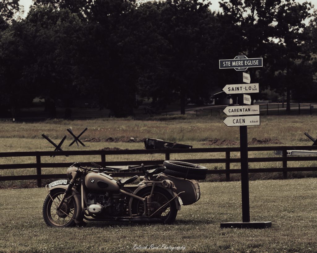 Documentary photographs of World War II reenactors at the Steam Railroading Institute, featuring authentic military uniforms, vintage trains, historical equipment, and living history demonstrations.