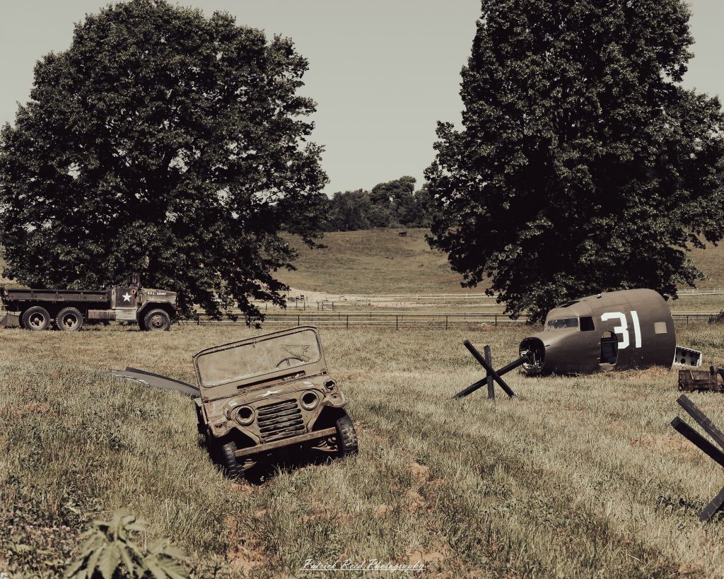Documentary photographs of World War II reenactors at the Steam Railroading Institute, featuring authentic military uniforms, vintage trains, historical equipment, and living history demonstrations.