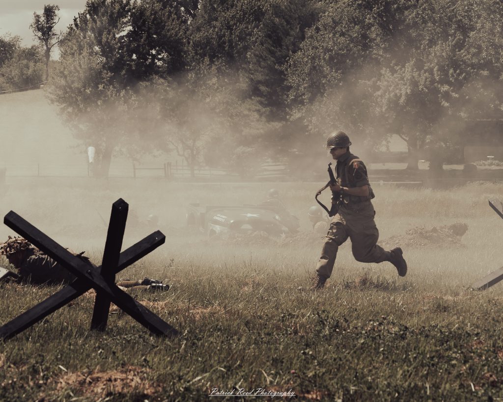Documentary photographs of World War II reenactors at the Steam Railroading Institute, featuring authentic military uniforms, vintage trains, historical equipment, and living history demonstrations.