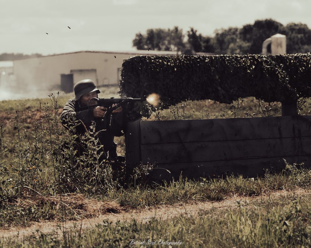 Documentary photographs of World War II reenactors at the Steam Railroading Institute, featuring authentic military uniforms, vintage trains, historical equipment, and living history demonstrations.