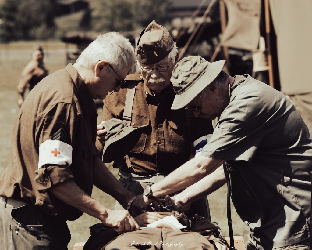 Documentary photographs of World War II reenactors at the Steam Railroading Institute, featuring authentic military uniforms, vintage trains, historical equipment, and living history demonstrations.