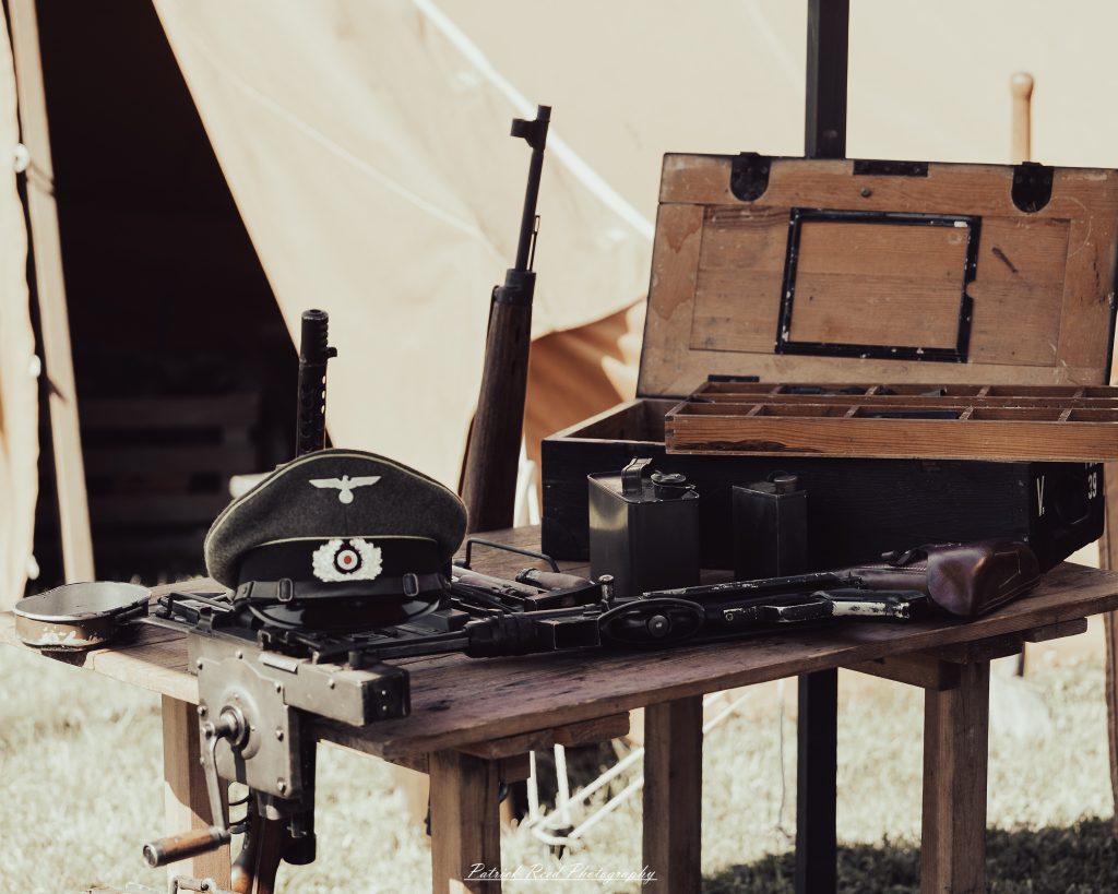 Documentary photographs of World War II reenactors at the Steam Railroading Institute, featuring authentic military uniforms, vintage trains, historical equipment, and living history demonstrations.