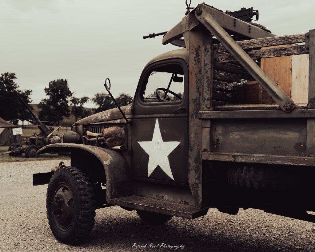 Documentary photographs of World War II reenactors at the Steam Railroading Institute, featuring authentic military uniforms, vintage trains, historical equipment, and living history demonstrations.