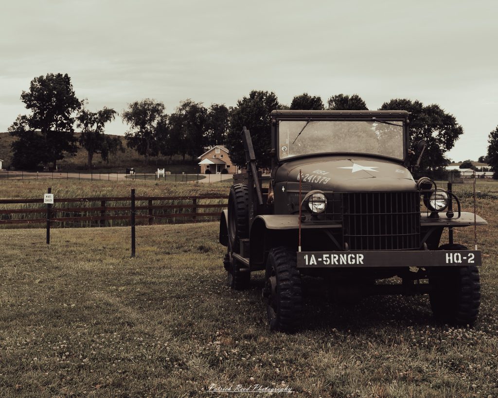 Documentary photographs of World War II reenactors at the Steam Railroading Institute, featuring authentic military uniforms, vintage trains, historical equipment, and living history demonstrations.