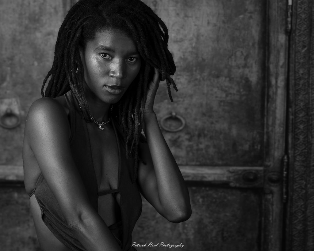 Studio editorial portraits featuring model Deja with dramatic lighting, fine-art black-and-white photography, contemporary fashion, and creative portraiture captured in a Detroit-area photography studio.