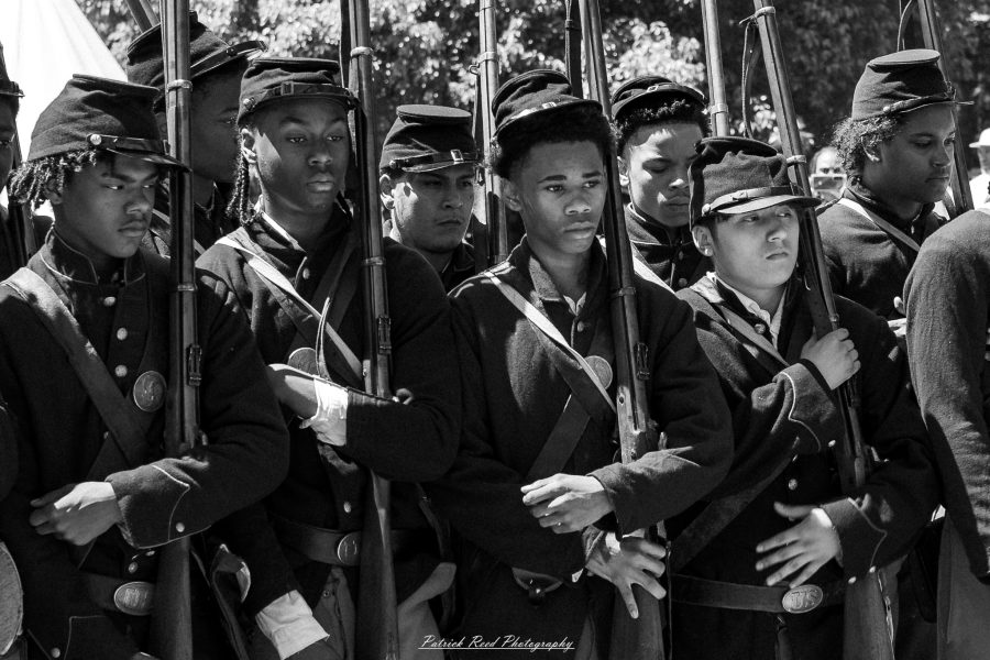 American Civil War reenactors at Greenfield Village in Dearborn, Michigan, dressed in authentic 19th-century military and civilian attire during a historical reenactment event.