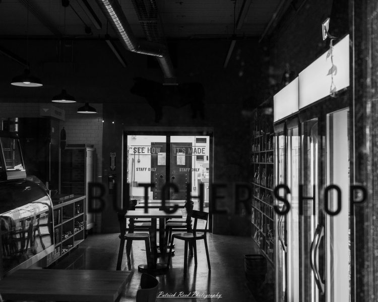 Backlit doors and banners in an industrial corridor, reading “SEE HOW IT’S MADE” and “STAFF ONLY.”